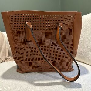Leather tote with laser cut geometric pattern detailing on front